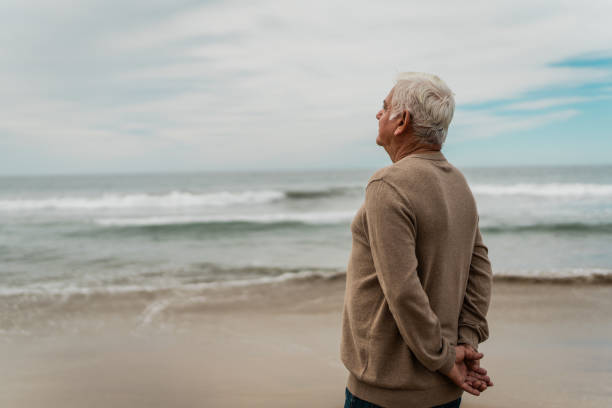 Person reflecting by the ocean